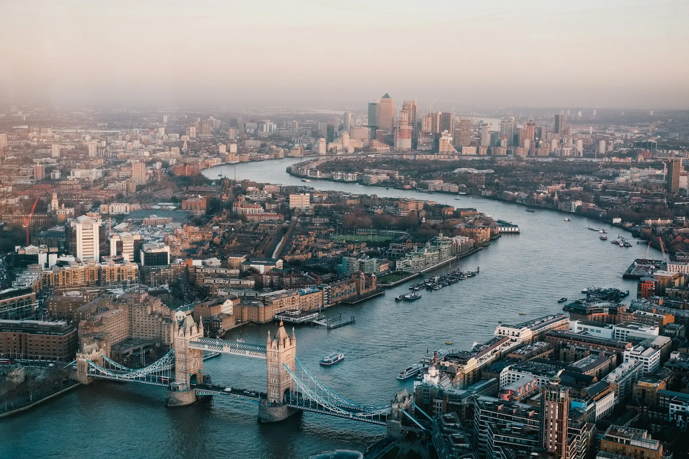 Aerial view of the River Thames, Tower Bridge and Canary Wharf in London